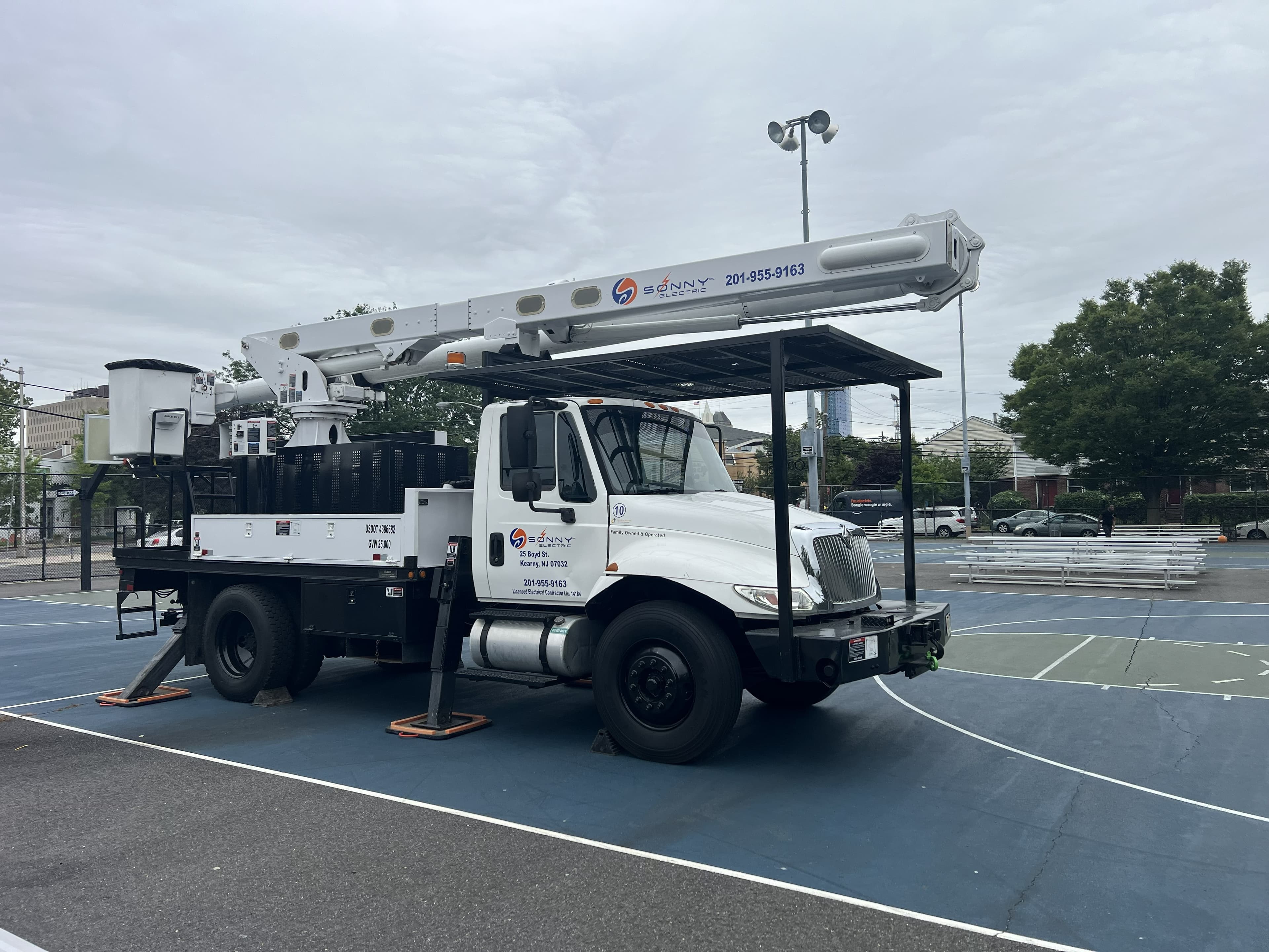 Sonny Electric bucket truck at a school site